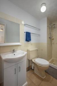 a bathroom with a toilet and a sink and a shower at Royal Oakwell Hotel in Blackpool +22 photos