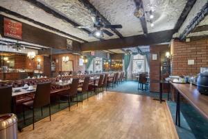 a dining room with tables and chairs and a bar at Royal Oakwell Hotel in Blackpool