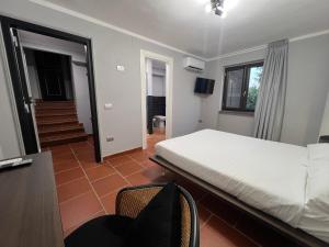 a bedroom with a bed and a desk and chairs at InVilla in Naples +4 photos