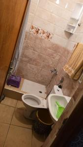 a bathroom with a toilet and a sink at Maison in Salé