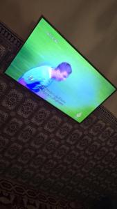 a television screen with a picture of a man on it at Maison in Salé