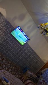 a flat screen tv on the ceiling of a room at Maison in Salé