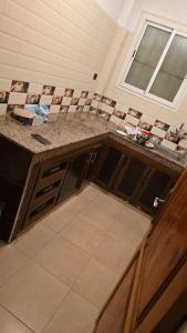 a kitchen with a counter top and a window at Maison in Salé