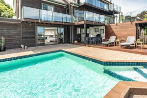 a swimming pool in front of a house at Hillside Haven in Whanganui