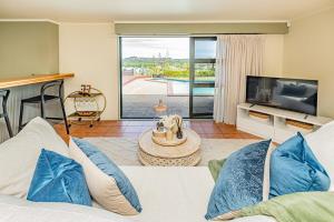 a living room with a couch and a television at Hillside Haven in Whanganui