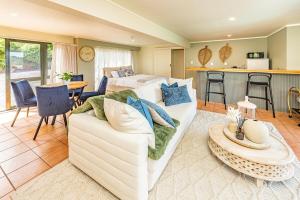 a living room with a couch and a bed at Hillside Haven in Whanganui