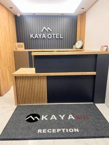 a reception desk with a kawi outlet sign on it at Kaya Hotel in Antalya