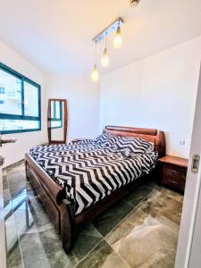 a bedroom with a zebra print bed in a room at Tiberias 521 in Tiberias