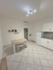 a kitchen with a wooden table in a room at Home Sweet Home Forli in Forlì +4 photos