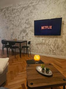 a living room with a television on a wall at Modern Apartment - Capljina Center in Čapljina