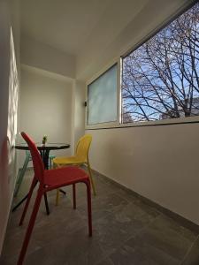 a room with two chairs and a table and a window at Modern Apartment - Capljina Center in Čapljina