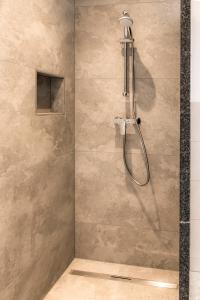 a shower with a shower head in a bathroom at Peterlehen Appartements in Altenmarkt im Pongau