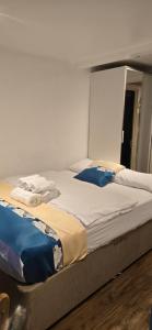 two large beds in a room with a mirror at Exclusive Private One Bedroom Suite in London +9 photos