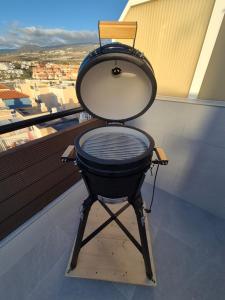 a grill sitting in a room with a window at Paraiso View Duplex Penthouse in Callao Salvaje