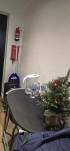 a table with a christmas tree on top of it at Exclusive Private One Bedroom Suite in London