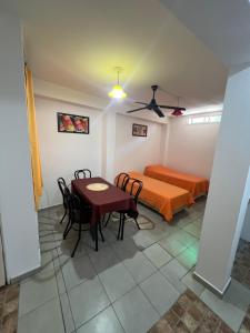 a room with a bed and a table and chairs at La casa del varón in Mina Clavero