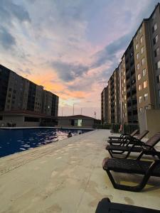 een rij stoelen naast een zwembad bij Loft Vacaciional in Ricaurte