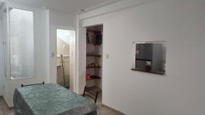 een witte kamer met een tafel en een spiegel bij Dúplex con Patio in San Miguel de Tucumán