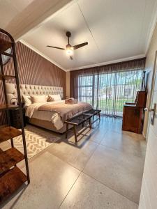 a bedroom with a bed and a ceiling fan at Forestview Luxury Farm Stay in Bellcrest