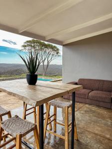 a wooden table and chairs in a room with a couch at Forestview Luxury Farm Stay in Bellcrest