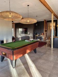 a living room with a pool table and chandeliers at Forestview Luxury Farm Stay in Bellcrest