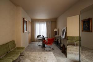 a living room with a couch and a table at Hotel Oculto in Mexico City