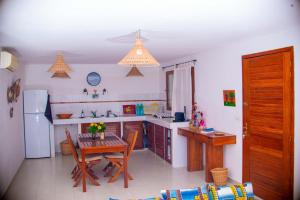 a kitchen with a table and a kitchen with a refrigerator at 20 ' keur in Boukot Ouolof