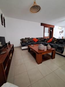 a living room with a couch and a coffee table at 20 ' keur in Boukot Ouolof