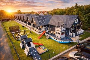 an aerial view of a house with a playground at Domeczki Blaneczki Wicie - domki letniskowe nad morzem in Wicie