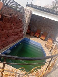 a pool of water in a hammock on a patio at Luxury 3 Bedroom Duplex with Mini Swimming Pool in Enugu