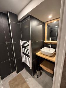 a bathroom with a sink and a mirror at Le Touring in Isola +13 photos