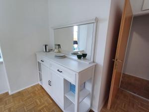 a white dresser with a mirror in a room at Apartment Gletscher & Fluß in Penk