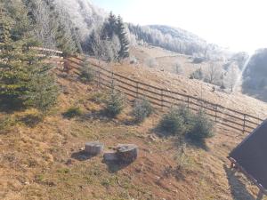 an aerial view of a hill with a fence at Independent Chalet in Şirnea +16 photos