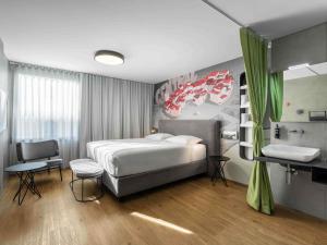 a bedroom with a bed and a sink in it at ibis Styles Ljubljana Centre in Ljubljana