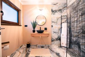 a bathroom with a sink and a mirror at Imperial Home Chalet in Sibiu +50 photos