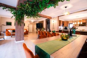 a living room with a dining table and a living room at Imperial Home Chalet in Sibiu