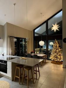 a kitchen with a table and a christmas tree at Aurora Arctic Riverside Villa in Rovaniemi