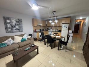 a living room and kitchen with a couch and a table at Casa Gloria in Los Abrigos +11 photos