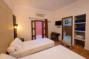 Ένα ή περισσότερα κρεβάτια σε δωμάτιο στο Gite Souss