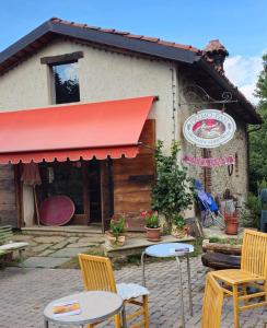 a restaurant with tables and chairs in front of a building at La Casa di Paolo in Battifollo +4 photos
