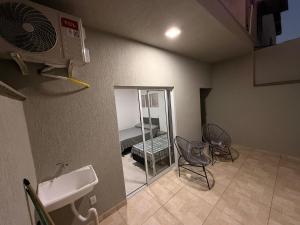 a room with a bathroom with a mirror and a sink at Flats Privativos MaragoJulios in Maragogi +37 photos