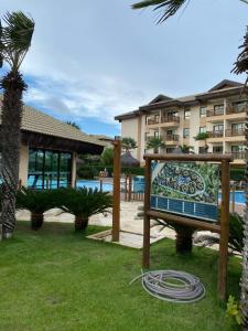 a sign in front of a resort with a pool at Bungalow Frente Mar N 101 in Caucaia