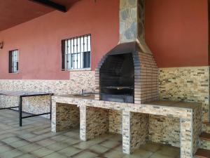 a kitchen with a fireplace in a room at Casa rural en Granada in Atarfe