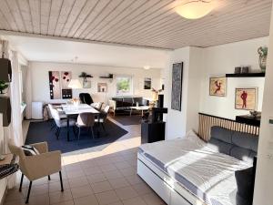 a bedroom and living room with a bed and a dining room at Amtoft Vig Kitespot in Vesløs