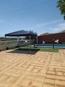 a black canopy on the deck of a house at Casa rural en Granada in Atarfe