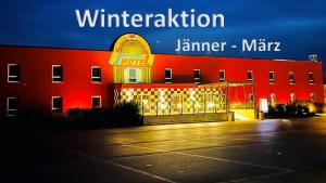 a red building with a sign on the front of it at Jukebox Hotel in Znojmo