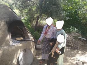 a group of people standing around an oven at Welcome home in Taounate
