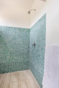 a bathroom with green tiled walls and a shower at La Buena vida Cabina 1 in Playa Grande +30 photos