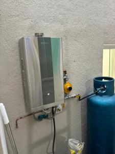 a television on a wall with a water tank at Morada Som do Mar in Governador Celso Ramos +16 photos