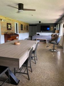 a living room with a large wooden table and chairs at The Holler in Andrews